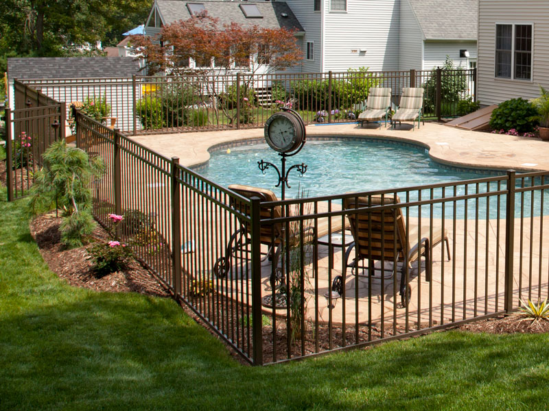 brown aluminum fence around backyard with pool