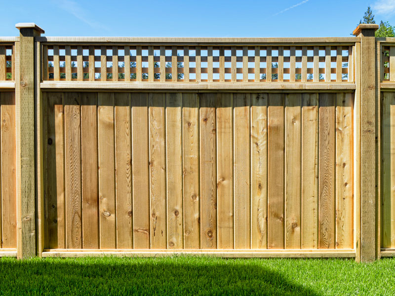 close up of tall wood privacy fence with lattice accent