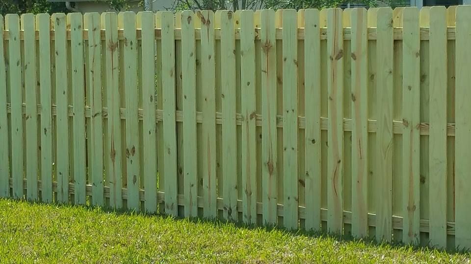 tall wooden picket fence