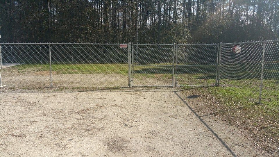tall silver chain link fence with gate opening